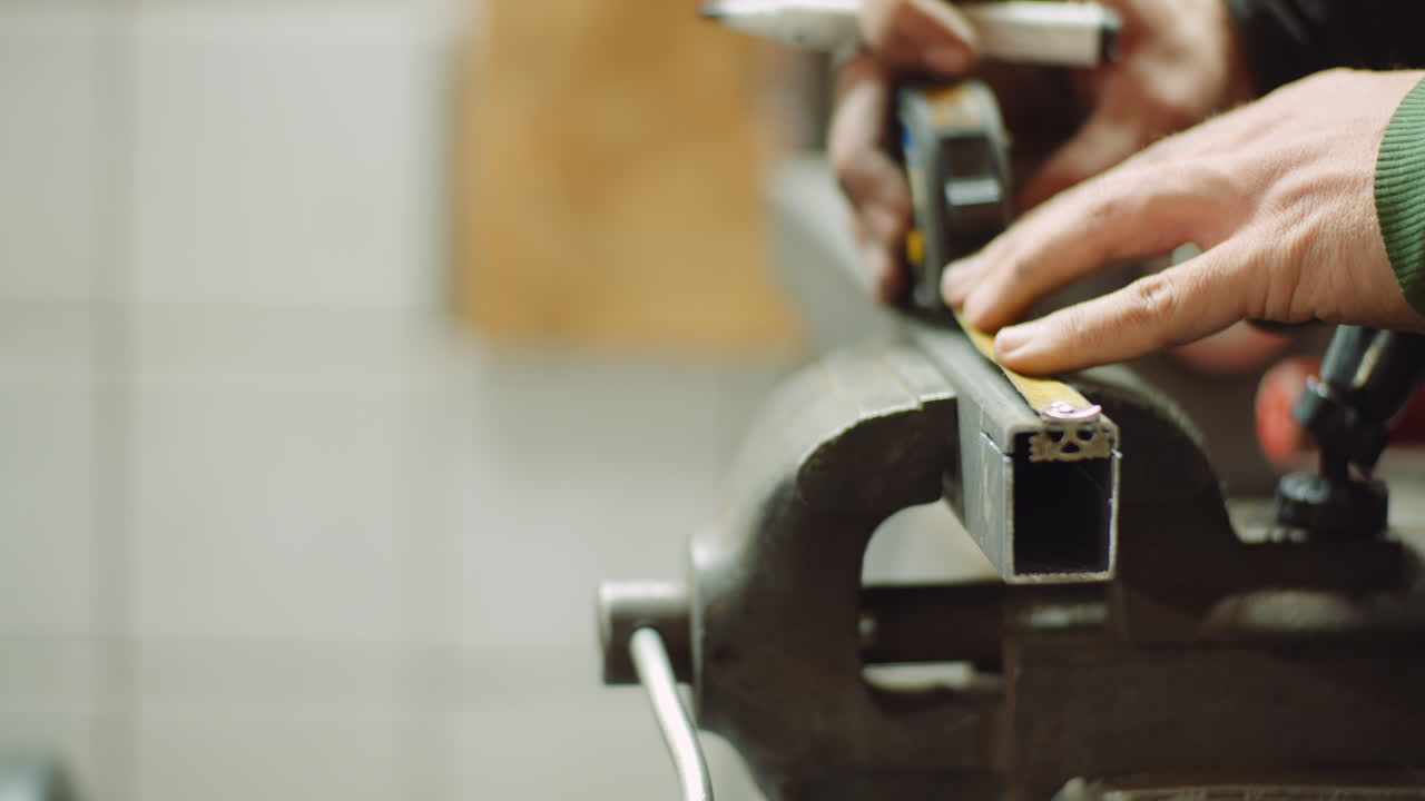 hombre que trabaja en la industria metalúrgica cortando y midiendo piezas metálicas en el taller 6