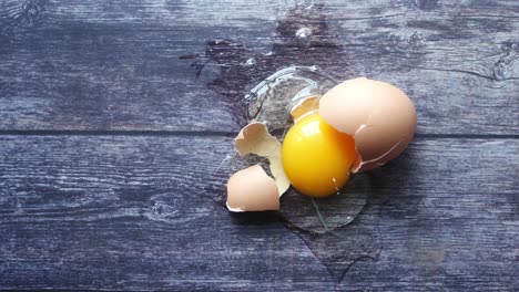 a cracked egg on a wooden table