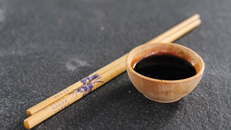 Chopsticks-and-soy-sauce-on-black-stone-slate