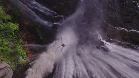 Drone-filming-powerful-waterfall-in-Indonesia-from-above,-aerial