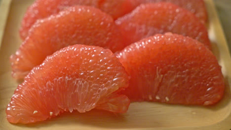 fresh red pomelo fruit or grapefruit on plate