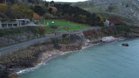 llandudno botanical gardens place name written in chalk aerial view above coastal landmark slow push in