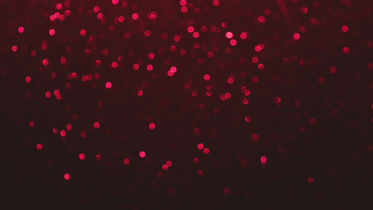 fondo bokeh de vibrante rubí rojo rosa profundo magenta y colores. cambiando pequeños círculos en la espalda oscura. vacaciones concepto de día de san valentín con espacio de copia