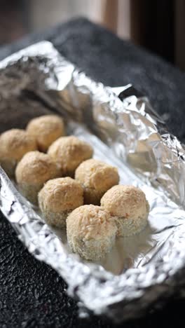 prepared sushi rolls in aluminum foil