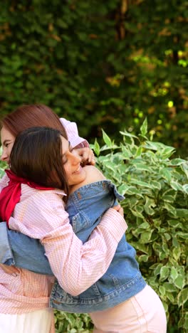 two girls hugging outdoors