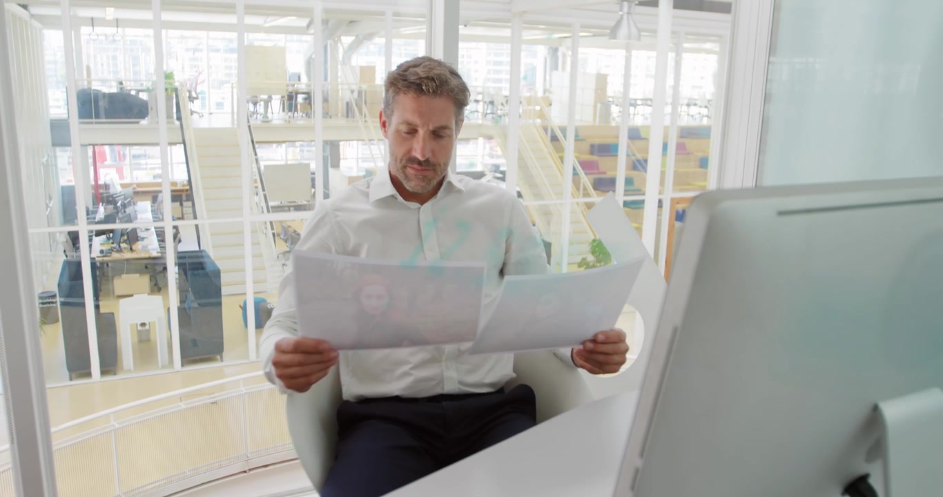 A happy business creative is working in a modern office, checking documents