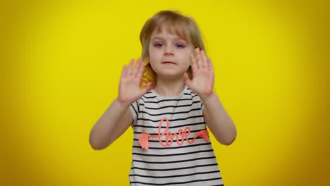 a young girl with blonde hair and a striped shirt smiles at the camera.