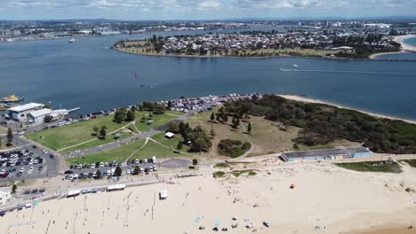 Aerial-view-of-a-beach-and-a-river-with-a-large-coastal-town