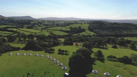 aerial filming of luxury bell tents in welsh countryside