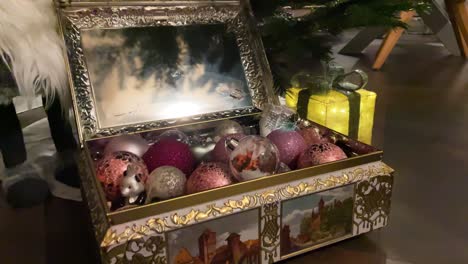 close-up of kid's hands taking christmas ball out of a beautiful box