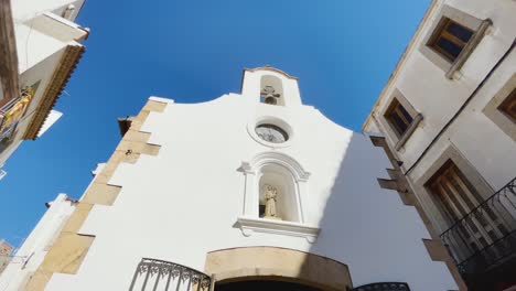 Small-chapel-Church-in-the-center-of-Tossa-de-Mar-Costa-Brava-within-the-province-of-Girona-in-Spain-if-the-background-blue