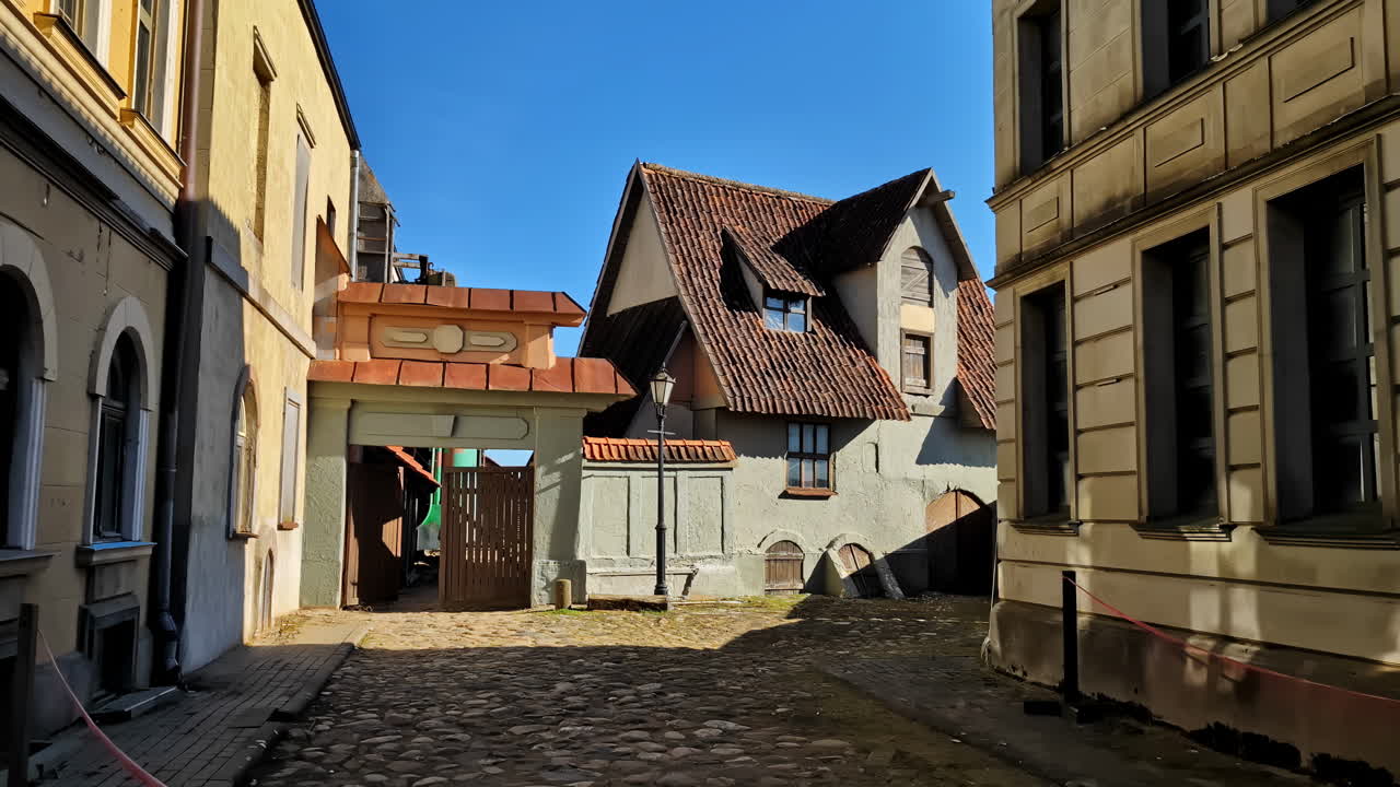 A quaint cobblestone alleyway in an old European town with historic buildings