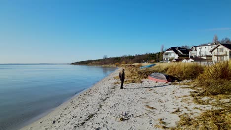 woman walking at the beach on a sunny day in kuznica, poland