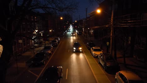 slow aerial rising shot of traffic coming head on during blue hour dusk