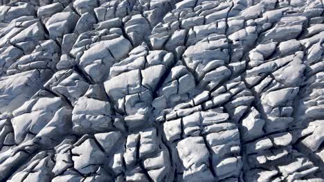 aerial overhead view of the cracks of the folgefonna glacier forming a pattern