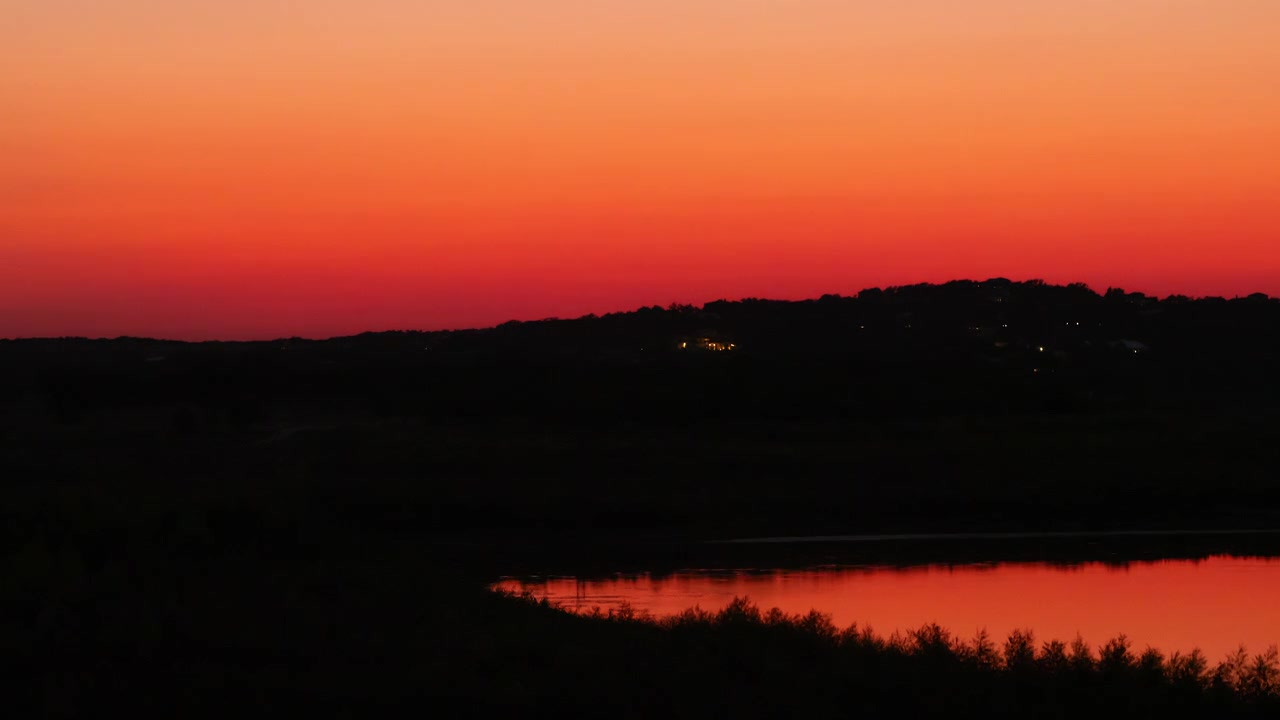 Texas Hill Country, hills in silhouette at Canyon Lake. Timelapse of vibrant twilight colors