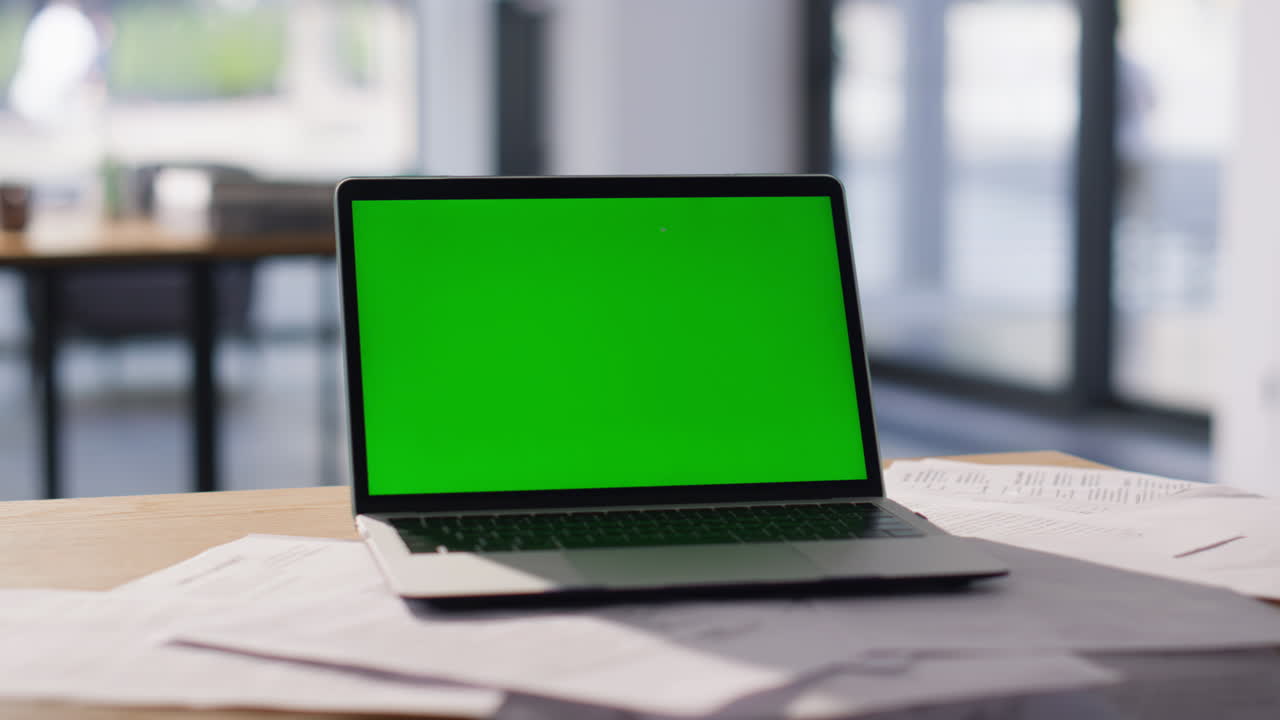 Chroma key laptop placed on modern workspace closeup. Green screen computer