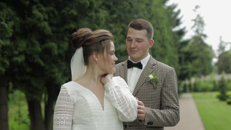 newlyweds. caucasian groom with bride walking in park. wedding couple. man and woman in love