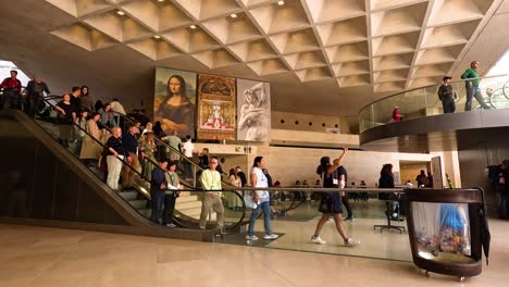 visitors moving around and observing paintings