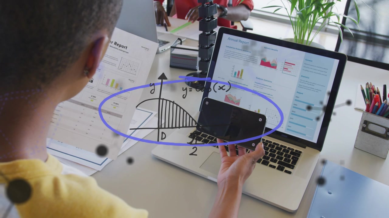 Business analyst holding phone over laptop while reading docs, animated graphs popping showing data