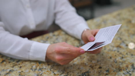 Woman at counter receiving hotel card. Hotel manager gives the key to the hotel room at the reception