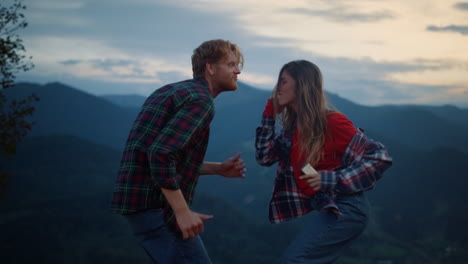 dancing couple have fun in mountains evening. happy lovers enjoy sunset outdoors
