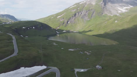 Cinematic-aerial-drone-shot-of-the-picturesque-Verney-Lake-located-along-the-Col-du-Petit-Saint-Bernard,-an-Alpine-mountain-pass-which-travels-through-the-Aosta-Valley,-Italy