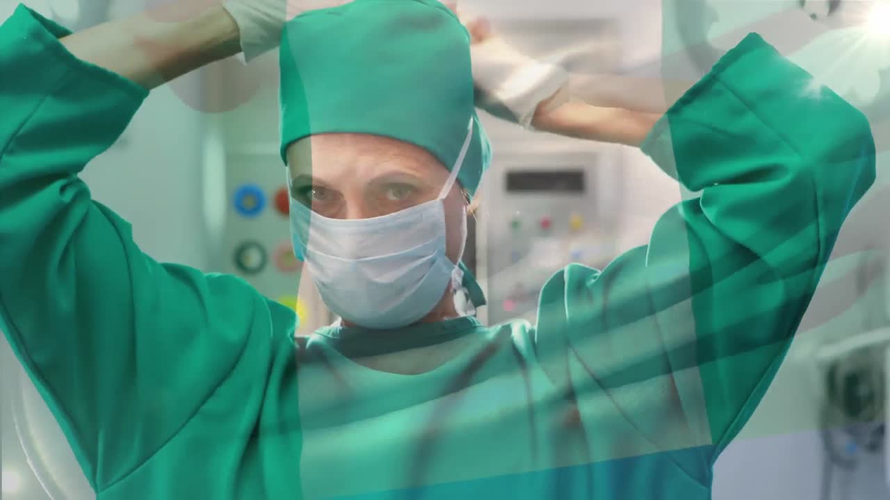animación de la bandera de nigeria ondeando sobre una cirujana en el quirófano