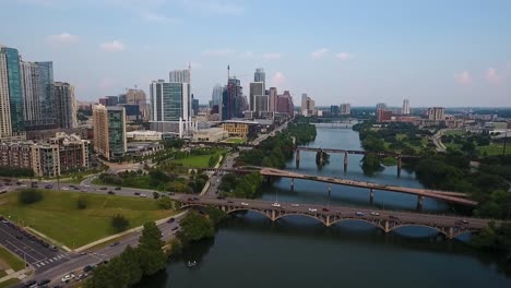 AERIAL:-Pulling-back-from-downtown-Austin,-Texas-on-a-beautiful-sunny-day