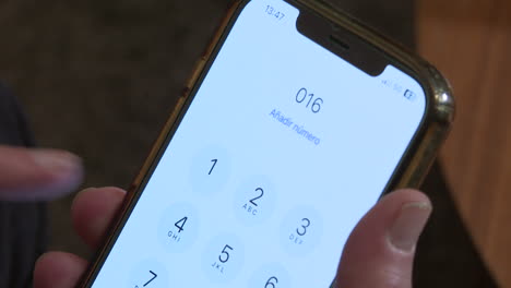 Person using a smartphone to make a phone call