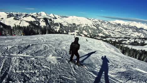 teenage boy snowboarding down the slope