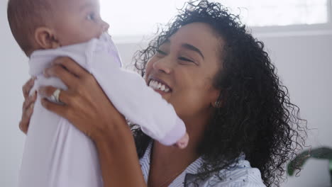 Loving-African-American-Mother-Wearing-Pyjamas-Playing-With-Baby-Daughter-In-Bedroom-At-Home