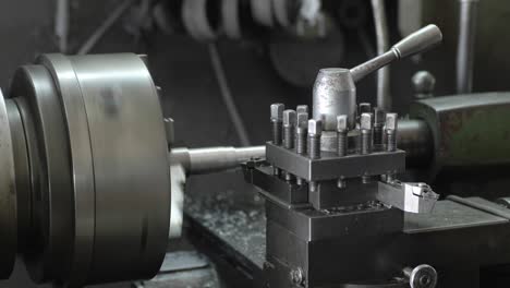 men's hands with a vernier caliper measuring the size of the details at work piece on lathe machine in the industrial factory. slow motion