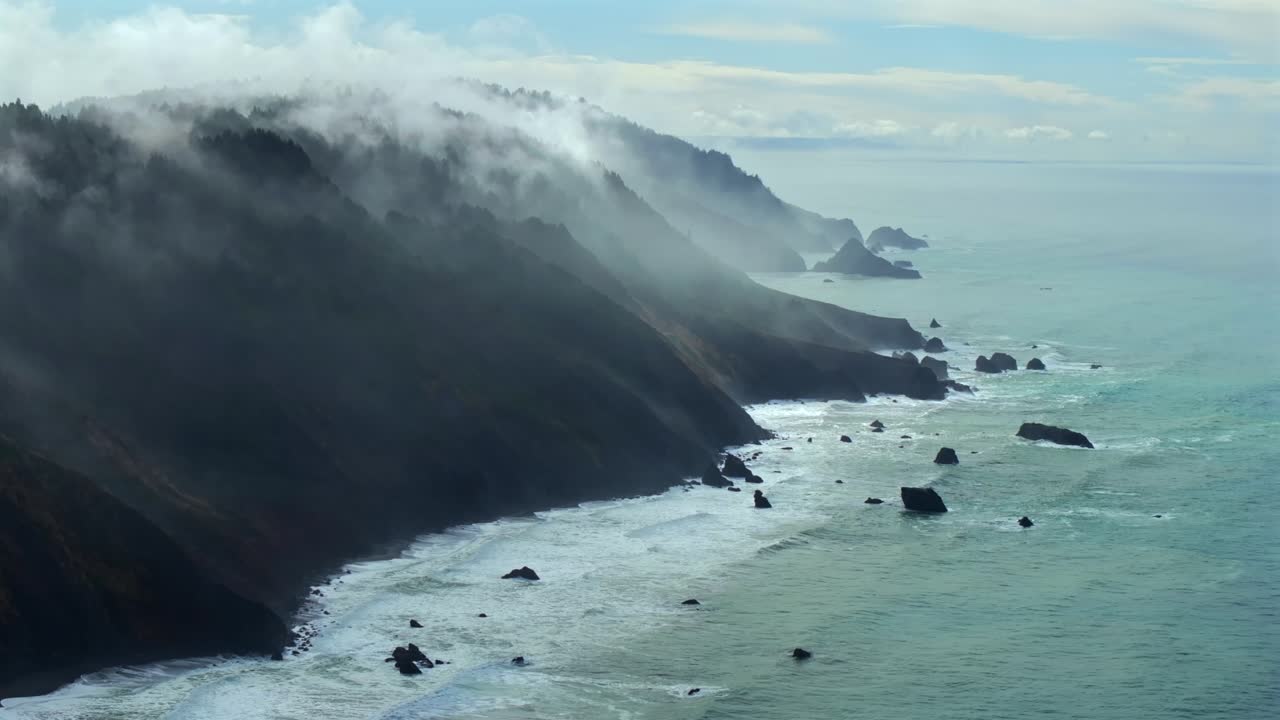 Rugged coastline Lost Coast Trail USAL Beach campground 4wd aerial drone California cloud layer blue sky mist rain fog PNW waves crashing morning Chimney Rocks nature landscape static shot