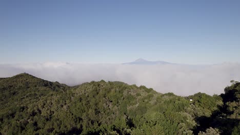 rising drone footage with a distant view of el teide from alto de garajonay on the island of la gomera