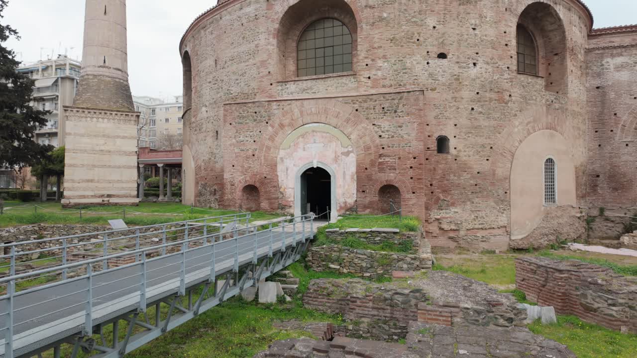 Tilt up from the ruins at the garden of Rotunda towards the beautiful 4th century domed circular building in Thessaloniki,Greece.
