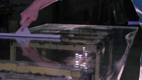 cleaning and maintaining glass table in a workshop