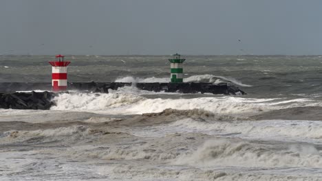Storm-at-sea,-winds,-big-waves-hit-lighthouses-at-Scheveningen,-Den-Haag,-The-Netherlands