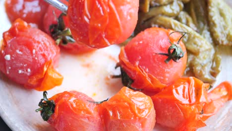 Baked tomato and capsicum on plate ,