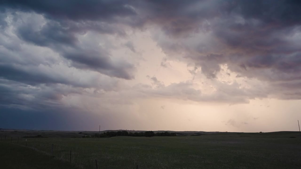Deep thunderclouds lit by bright lightning in the darkness