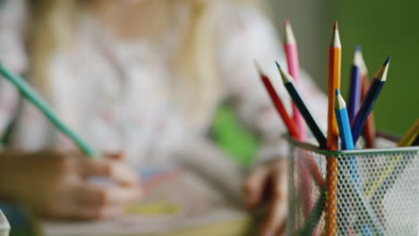 a girl is drawing - in the frame are only visible hands