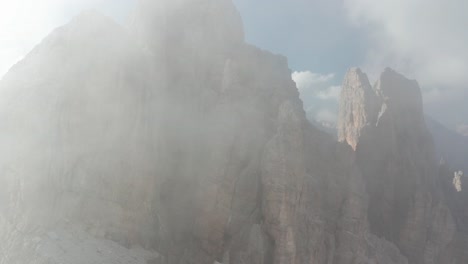 Aerial-of-Croda-da-Lago-mountain-peaks-with-low-clouds-and-sunshine