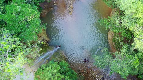 people in natural pool of limon waterfall, samana in dominican republic