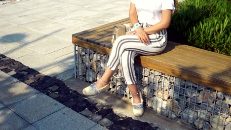 attractive woman sitting on bench swing