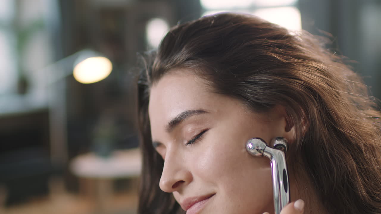 Woman Doing Facial Massage With Face Sculptor