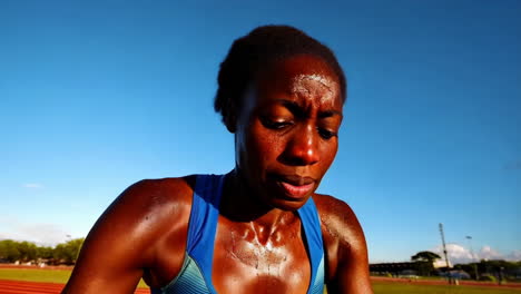 female athlete resting on track