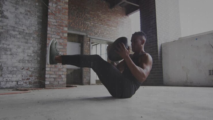 Man balancing V-sit holding medicine ball twisting torso left right updating fitness data charts