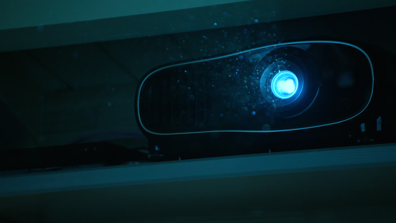 FOCUS PULL of particles in the powerful light to a home cinema projector