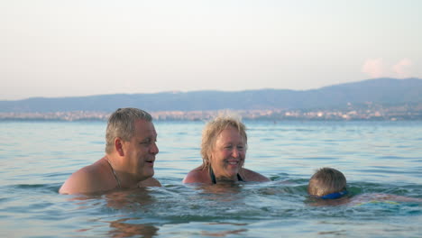 Little-boy-swimming-towards-his-grandparents