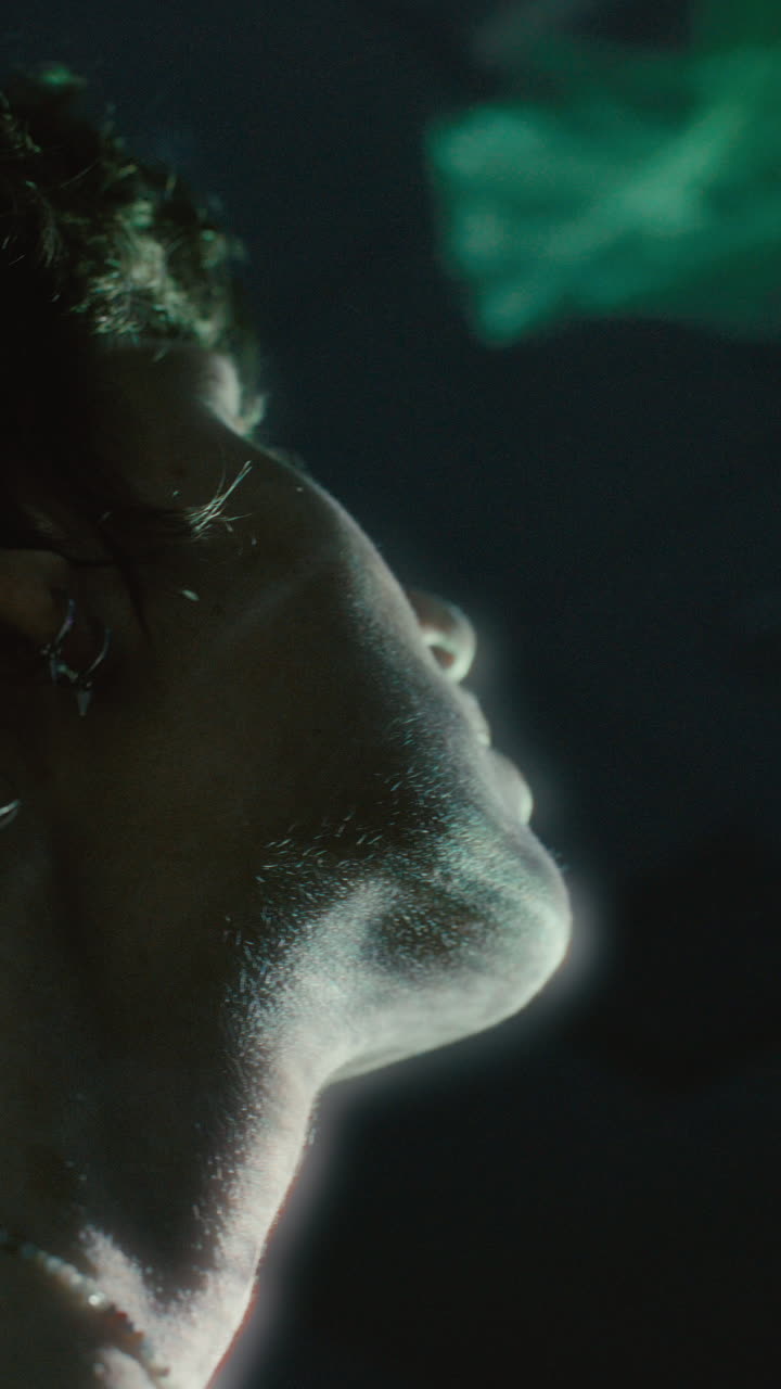 Woman Gazing Upward at Supernatural Colorful Light in Dark Room